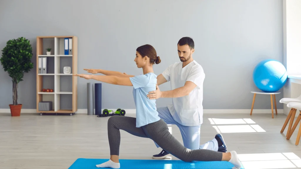 Physiotherapist guiding a woman through recovery exercises to improve mobility and reduce pain